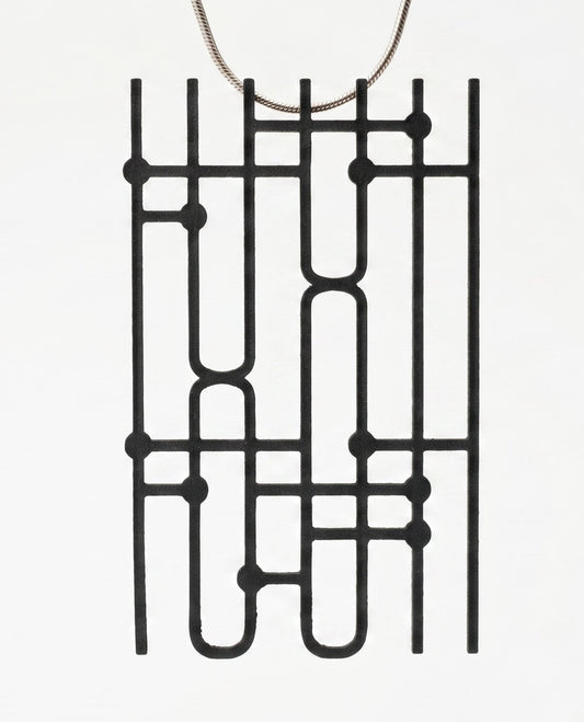 Black geometric pendant on a white background